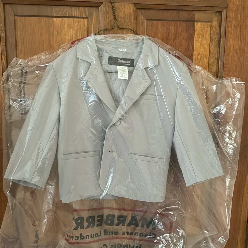 Freshly dry cleaned grey suit coat.